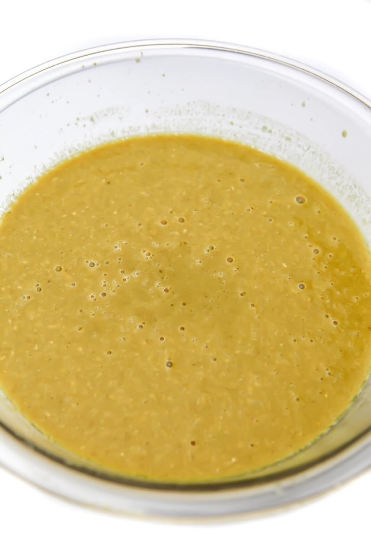 Broth and chickpeas blended then added to a glass bowl.