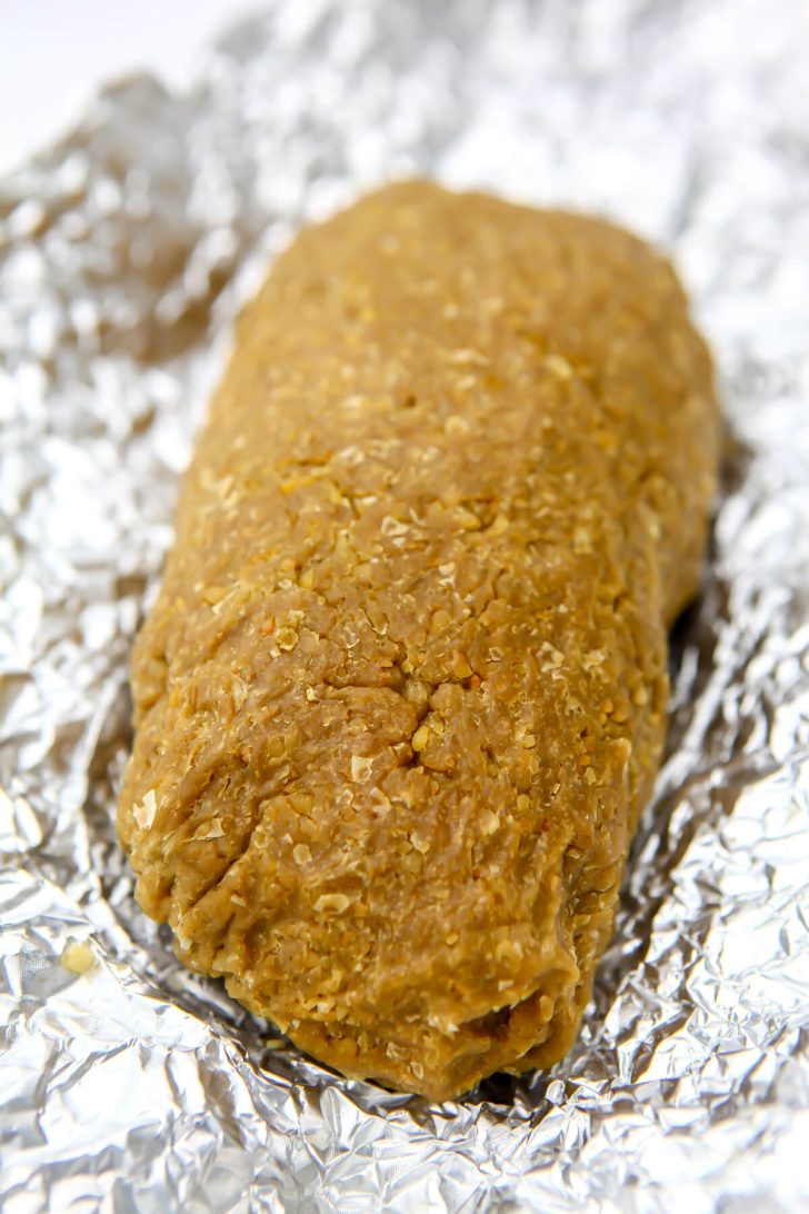 A vegan turkey after it has steamed in foil.