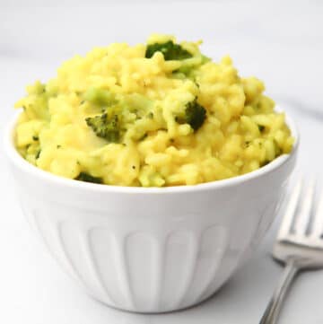 A white bowl filled with vegan broccoli risotto.