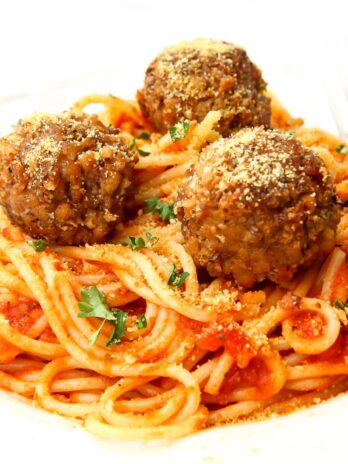 Vegan meatballs on a bed of spaghetti with marinara sauce.