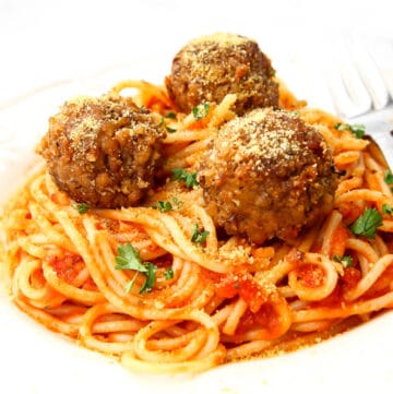 Vegan meatballs on a bed of spaghetti with marinara sauce.