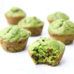 Bright green spinach muffins with chocolate chips in them.
