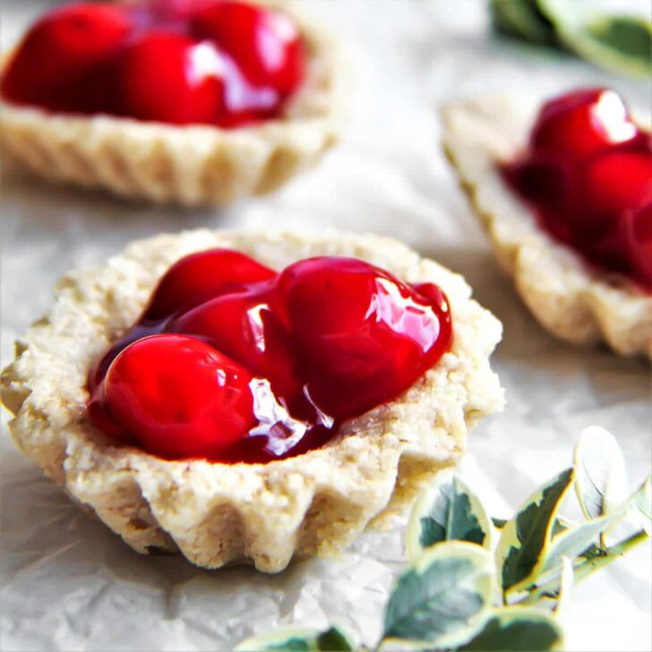A tray of sand bakkels - little vegan tarts filled with cherry pie filling.