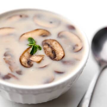 A white bowl filled with dairy free cream of mushroom soup.