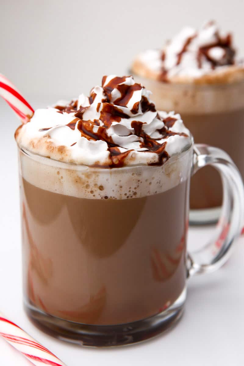 A close up of a cup of vegan hot chocolate in a glass mug.