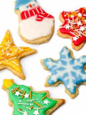 Vegan sugar cookies with vegan royal icing and sprinkles on top.