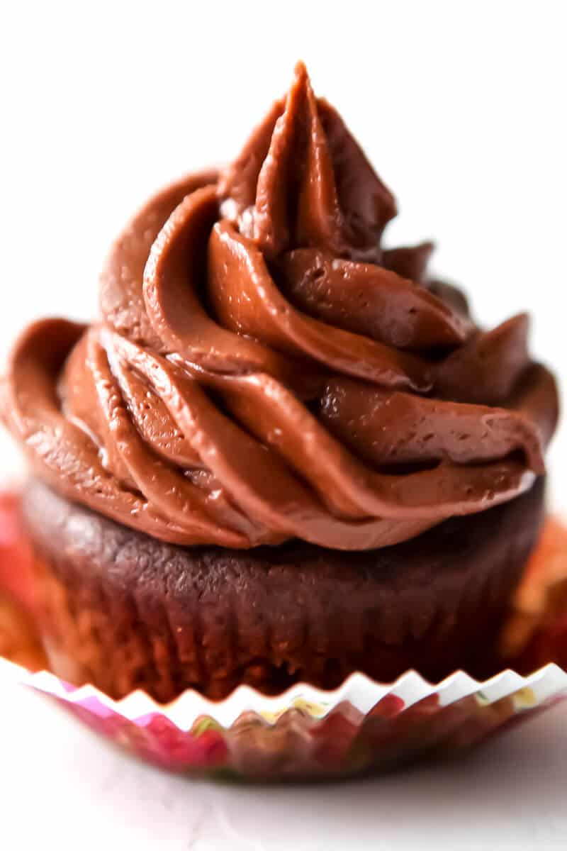 A vegan chocolate cupcake with vegan chocolate buttercream frosting.