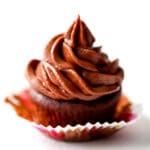 A chocolate cupcake topped with chocolate vegan buttercream.