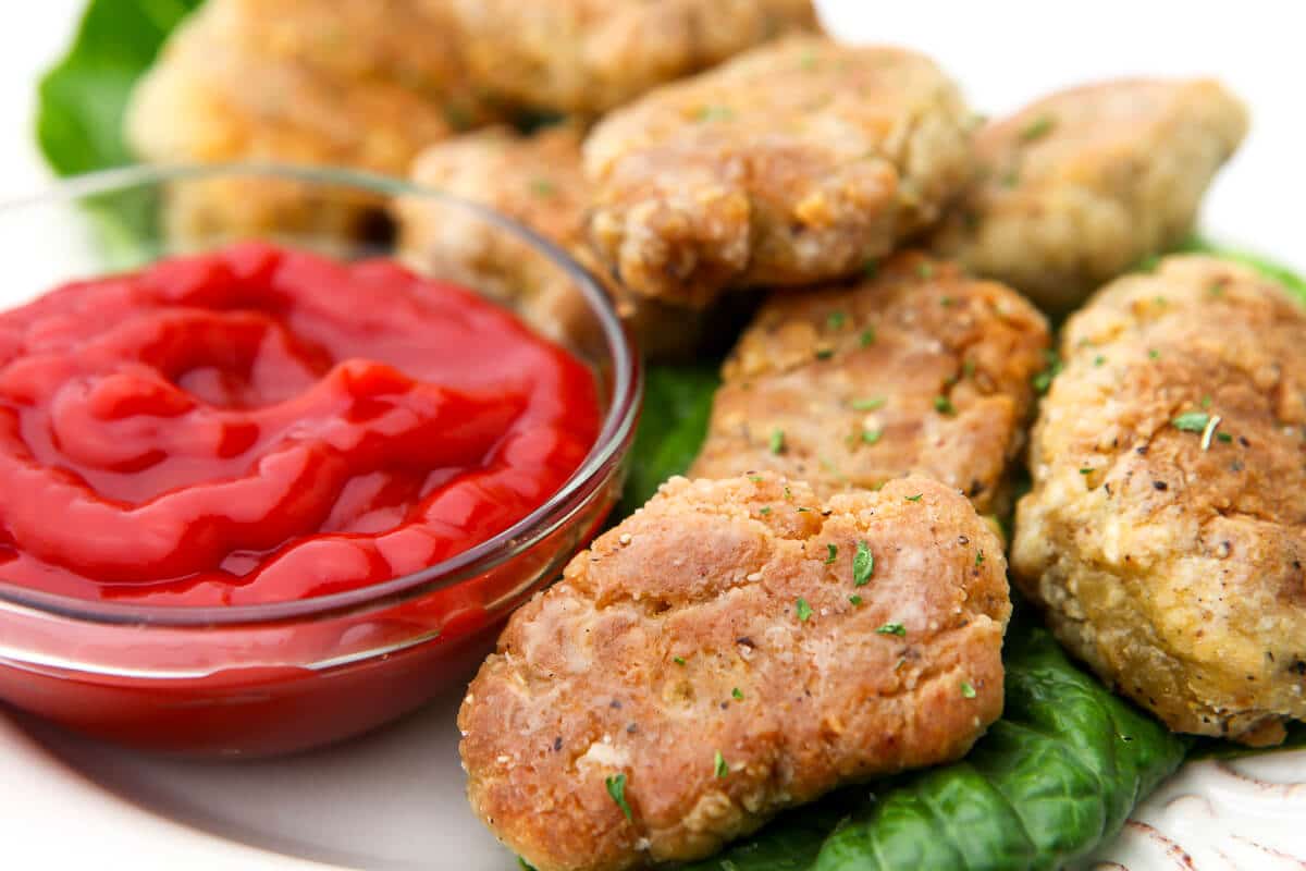 A close up of vegan chicken nuggets on a plate.