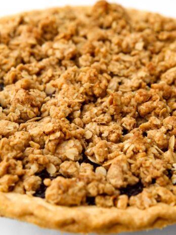 A pie with a vegan crumble topping baked until golden brown.