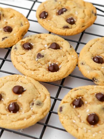 Vegan chocolate chip cookies on a cooling rack.