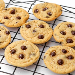 Vegan chocolate chip cookies on a cooling rack.