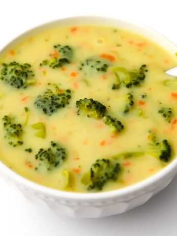 A top view of a white bowl filled with vegan cream of broccoli soup.
