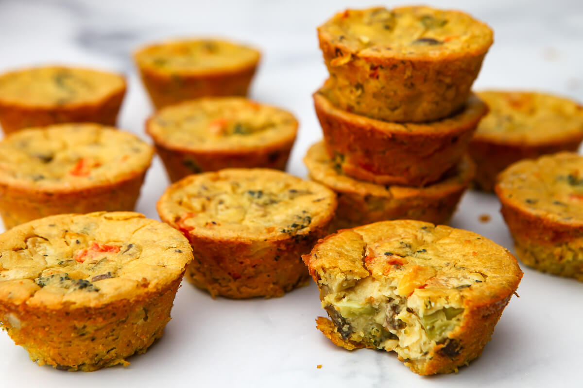 Vegan egg muffins stacked on a counter top after baking.