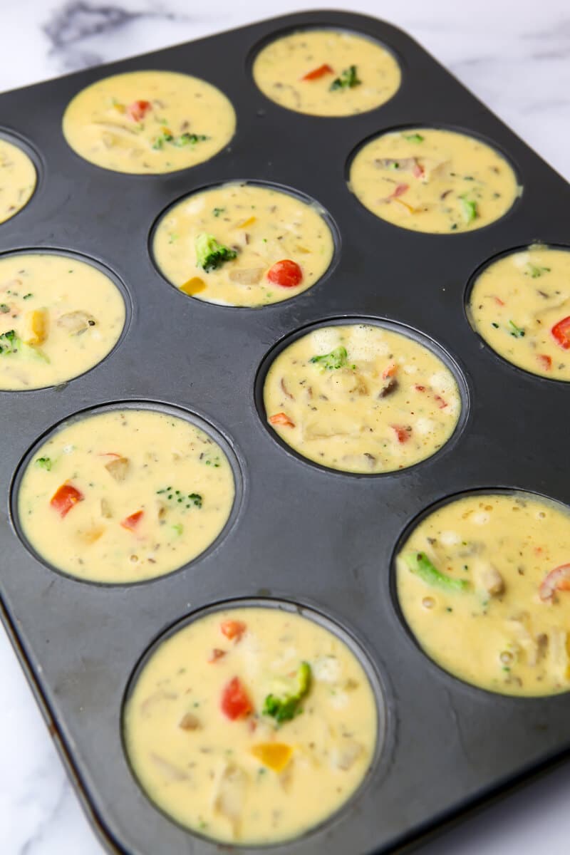 Muffin tin filled with vegan omelet batter.