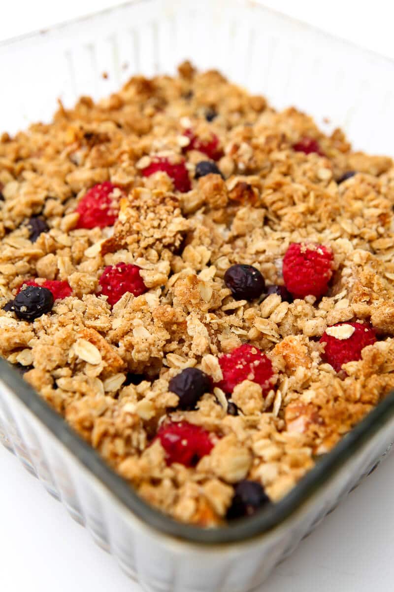 An egg-free French toast casserole with blueberries, raspberries, and crumble topping.