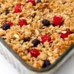 A vegan French toast casserole before it has been served with berries and a crumble crust.