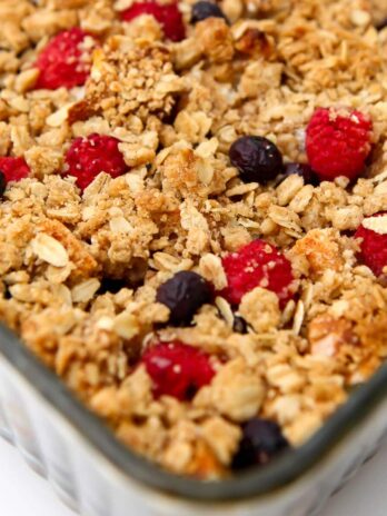 A vegan French toast casserole before it has been served with berries and a crumble crust.