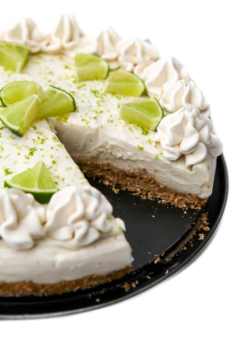 A dairy-free key lime pie with a slice cut out of it.