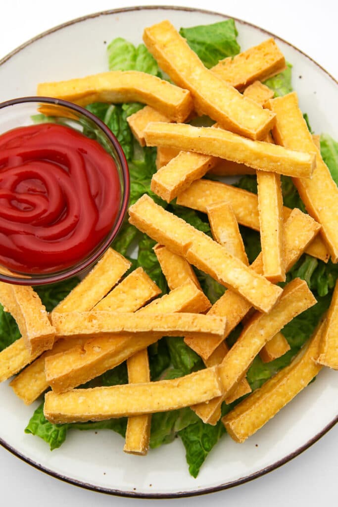 A top view of a plate of fries made from tofu.