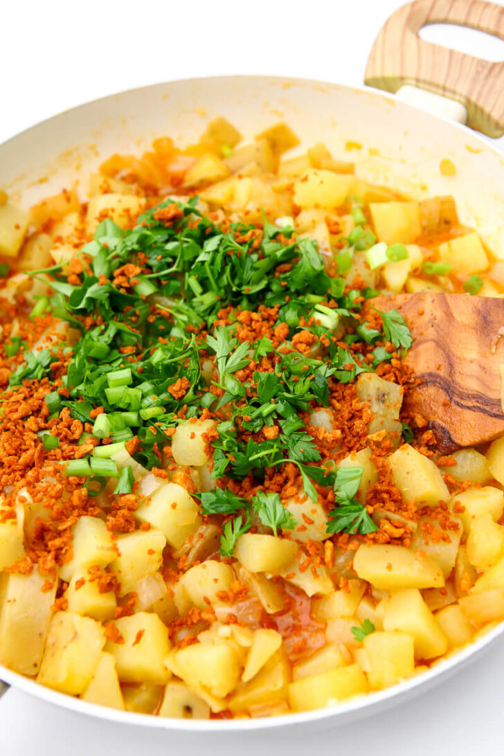 The potatoes herbs, and bacon bits added to the broth.