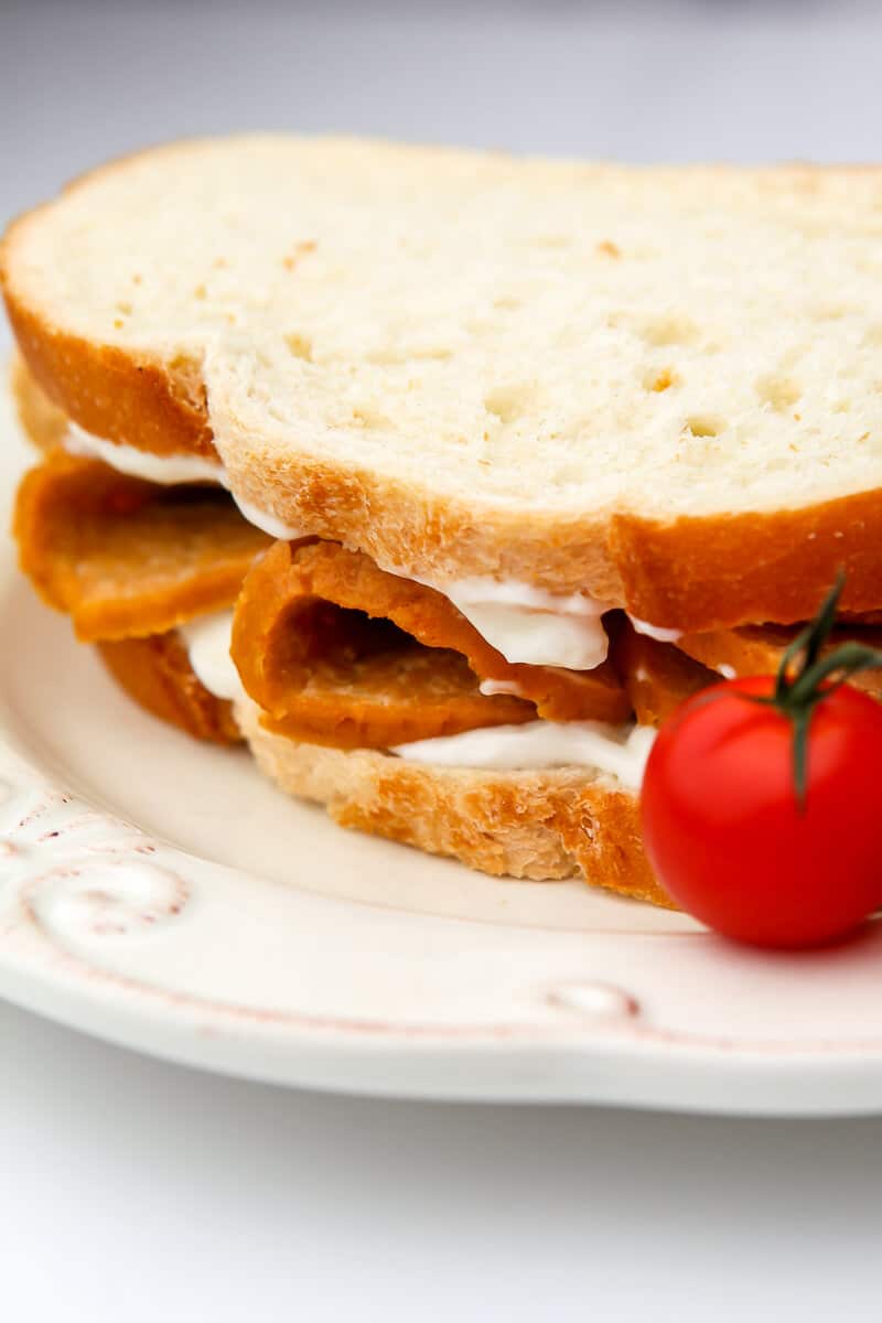 A vegan bologna sandwich made with homemade seitan bologna and mayo.