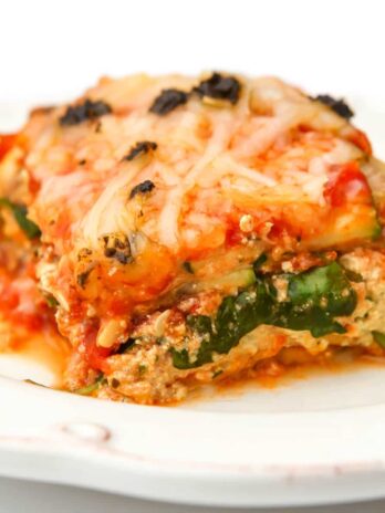 A slice of vegan zucchini lasagna on a white plate.