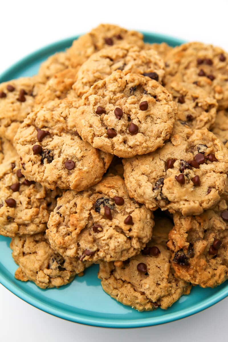 Oatmeal cookies with raisins and chocolate chips on a blue plate.