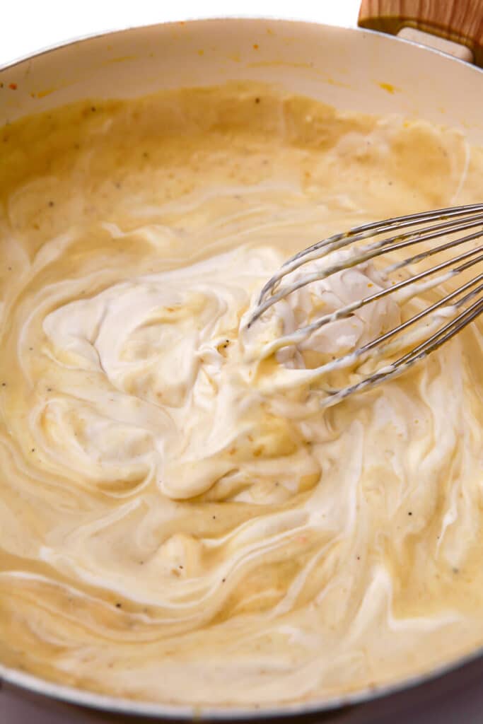 The process of making the dairy-free cream sauce for squash casserole.