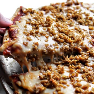 A pizza covered in vegan sausage crumbles made with TVP and spices.