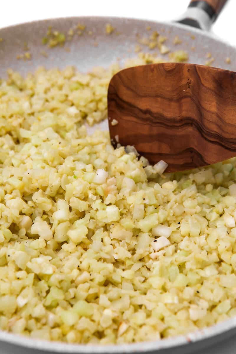 Riced cauliflower slowly sautéing in garlic butter.