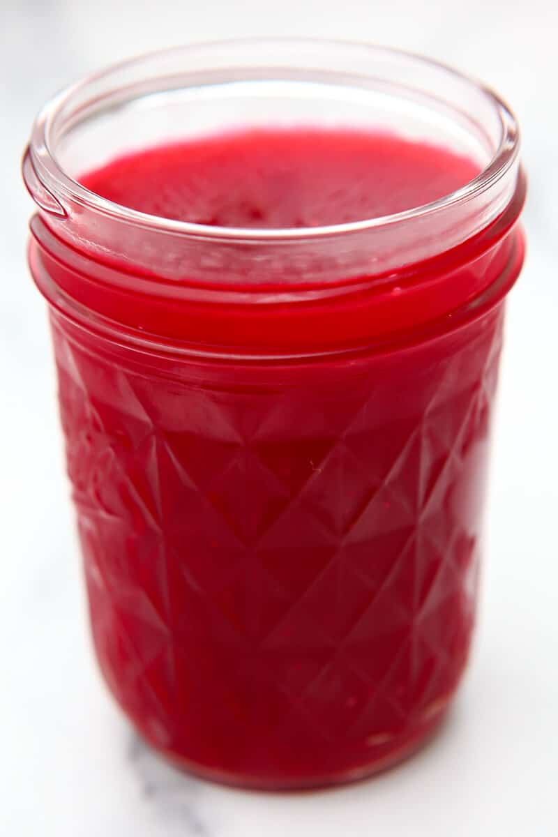 A jelly jar filled with jellied cranberry sauce.