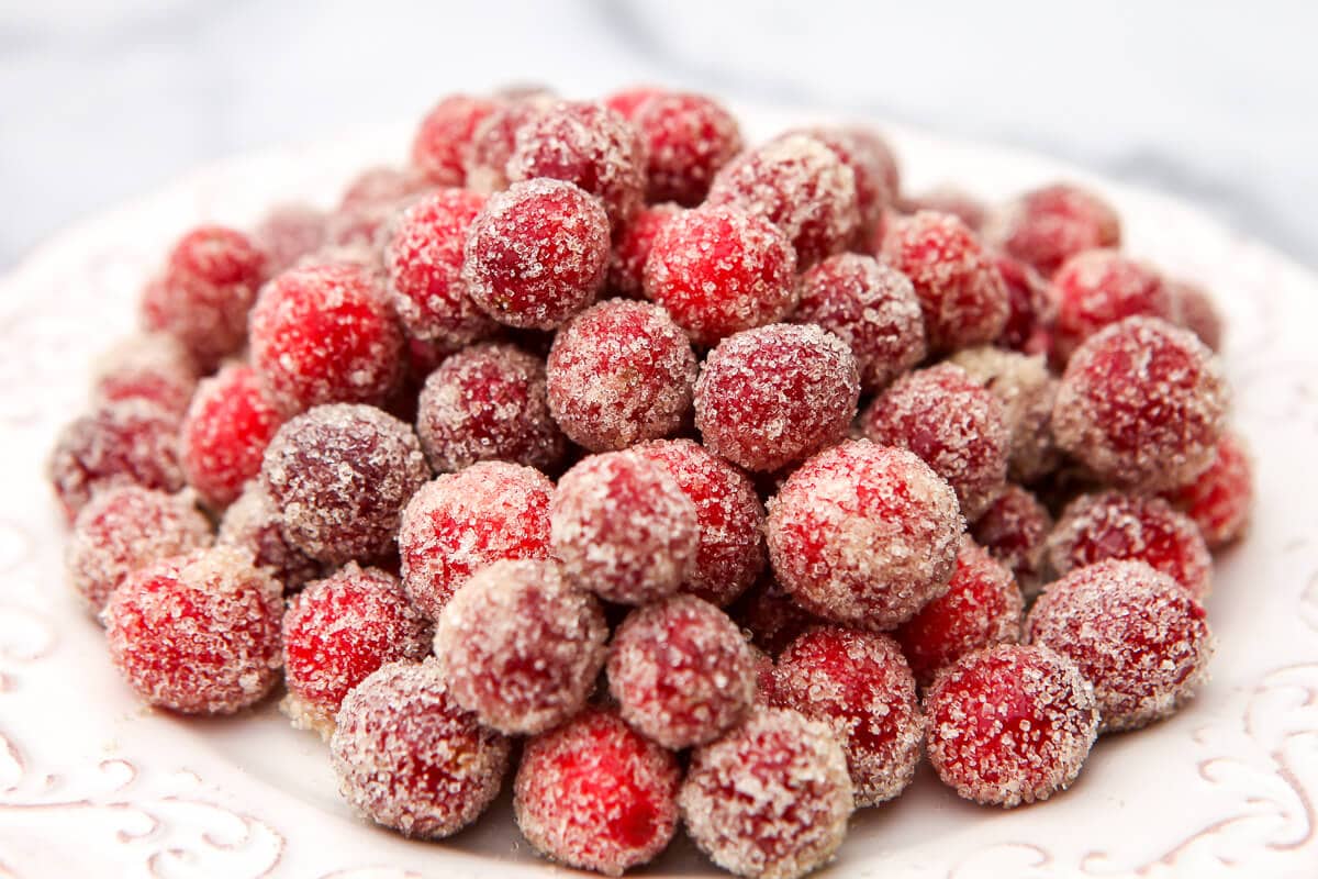 Sugared cranberries on a white plate.