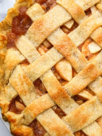 A top view of a vegan apple pie with a lattice topping.