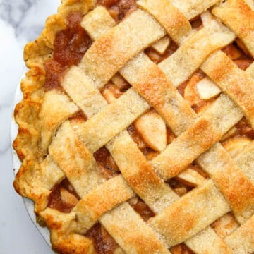 A top view of a vegan apple pie with a lattice topping.