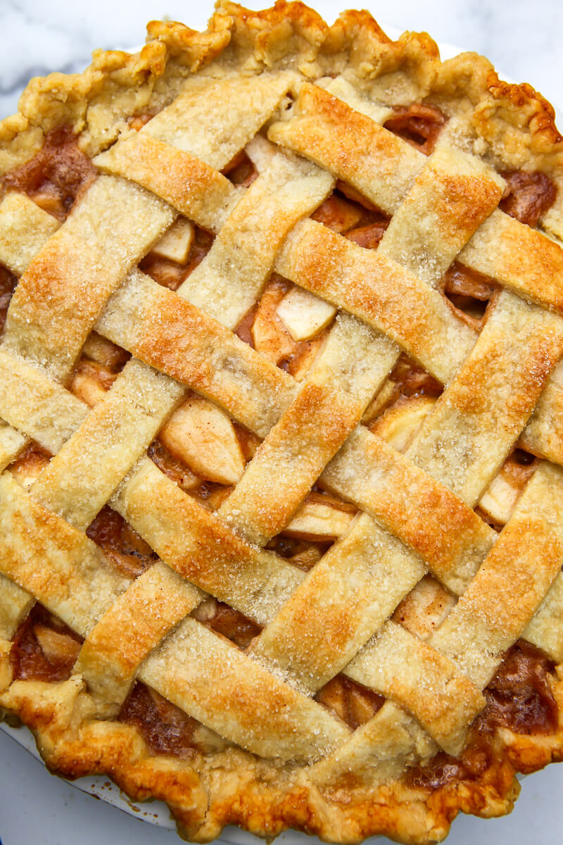 A top view of a vegan apple pie with a lattice top.