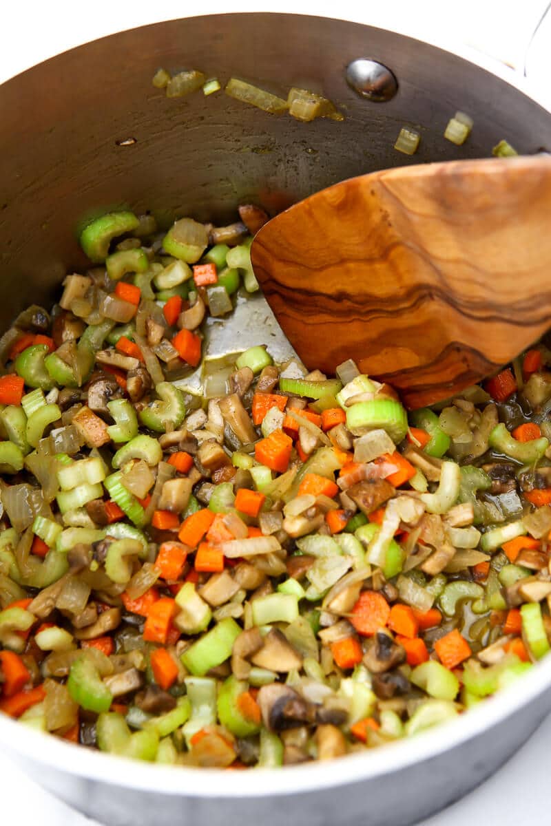 Vegetables sauteing in a pot to make vegan stovetop stuffing.