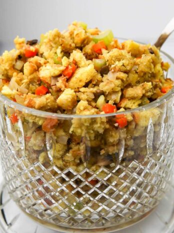 A glass bowl filled with vegan stovetop stuffing with vegetables.