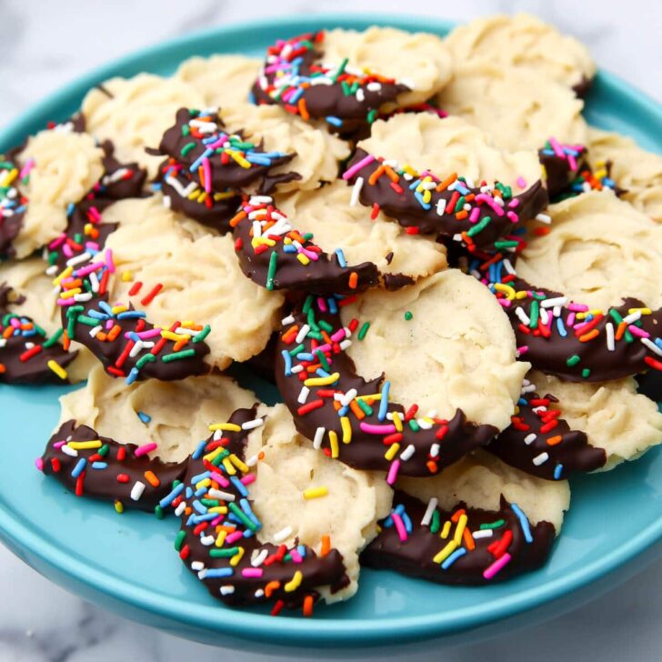A blue plate filled with vegan butter cookies.