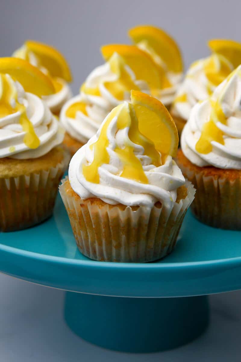 Vegan lemon cupcakes on a blue cake pan.