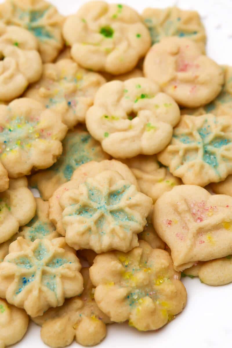 A white plate filled with dairy-free and egg-free spritz cookies.