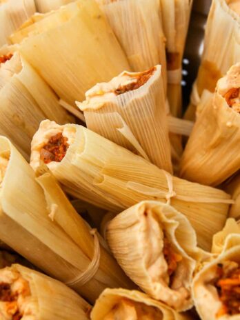 A close up of a pot full of vegan tamales ready to be steamed.