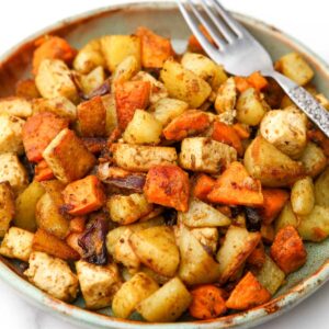 A plate full of roasted root vegetables and tofu.