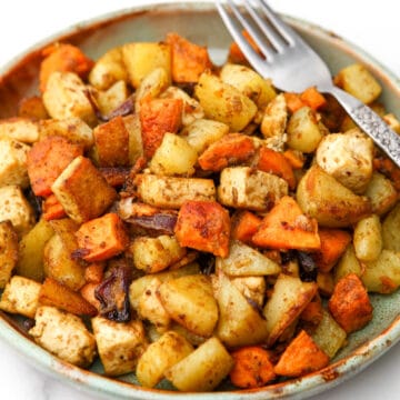 A plate full of roasted root vegetables and tofu.