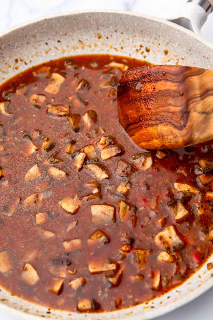 Mushrooms cooking in a broth to make the base of a beef flavored seitan.