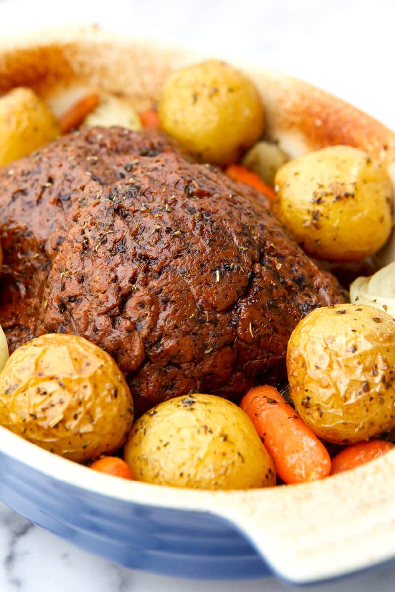 A vegan pot roast made with a vegan beef loaf with potatoes, carrots, and onions.