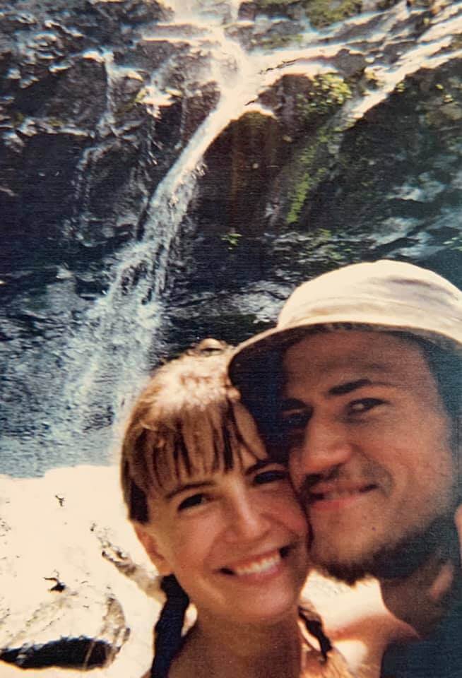 Monica Davis and her husband hiking the appalachian trail in front of a waterfall.