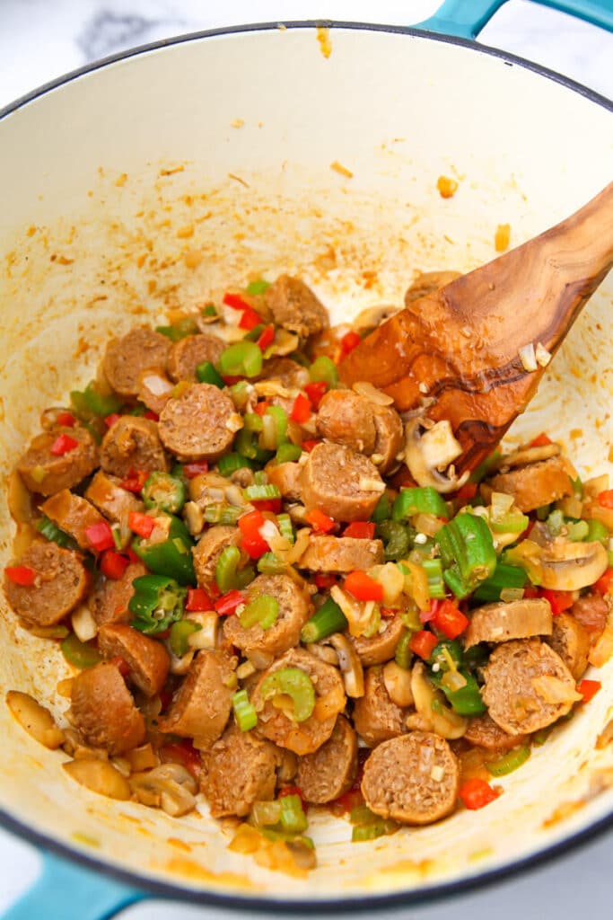 A pot of sautéed vegetables and vegan sausage.