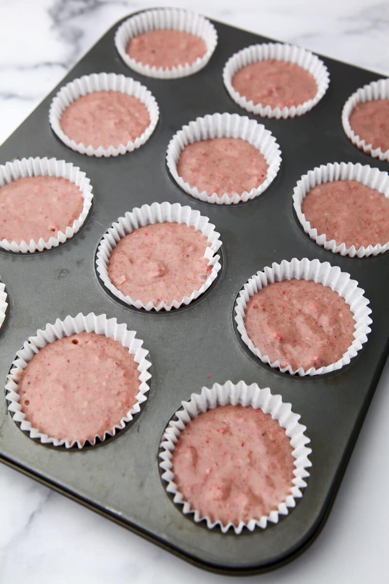 Strawberry cupcakes in a muffin tin  before they are baked.