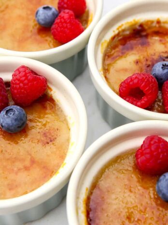 A top view of vegan creme brulee topped with berries.